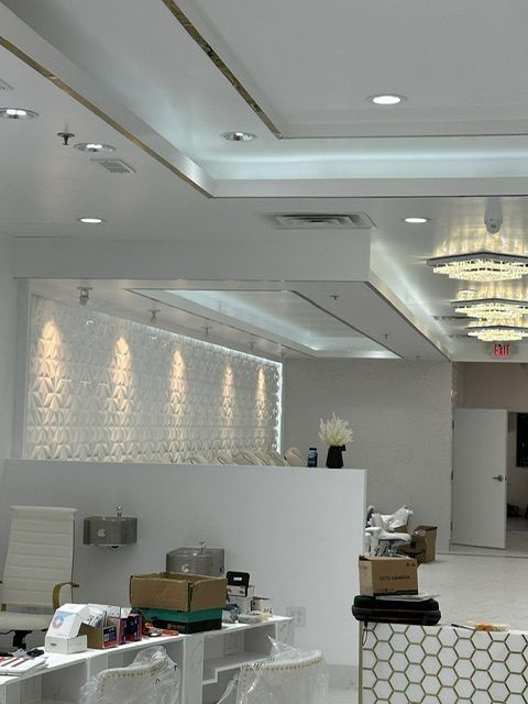 Commercial salon build-out with recessed lighting, wall washers and chandeliers
