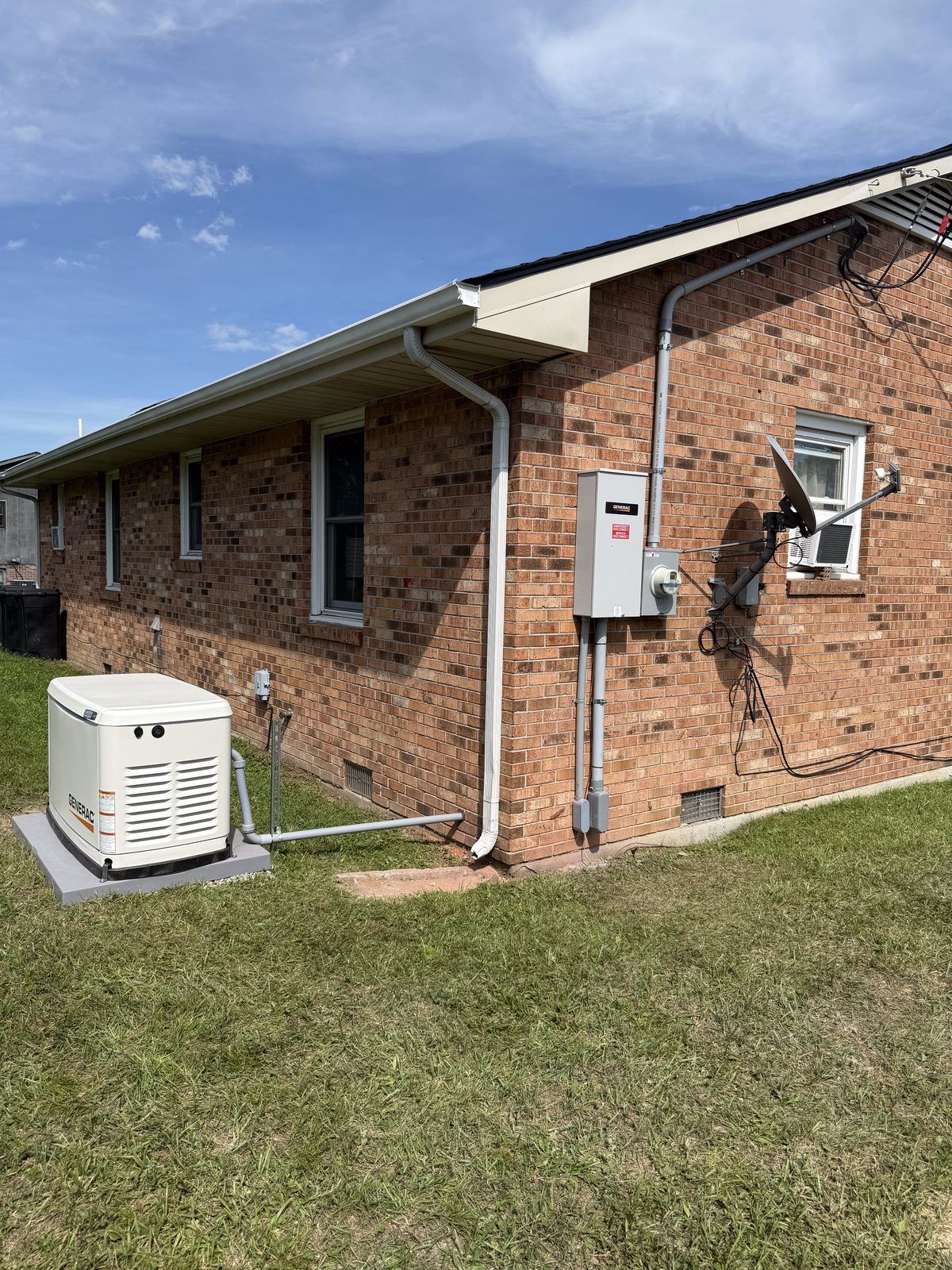 Standby generator and transfer switch installed on a brick home