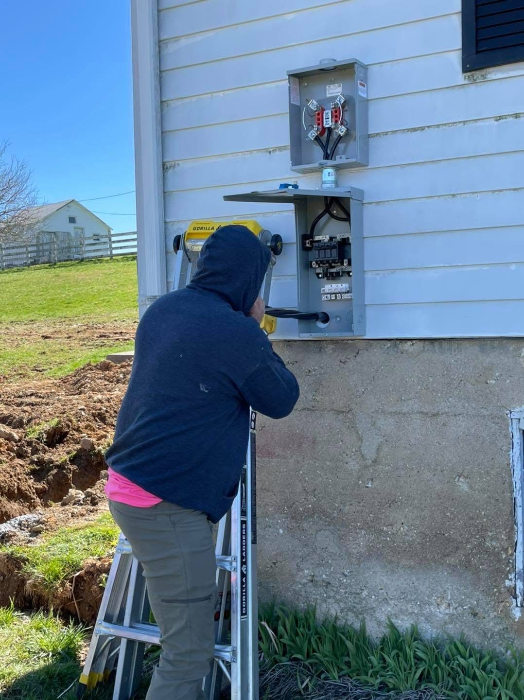 Electrician installing a new meter base and service disconnect on a home