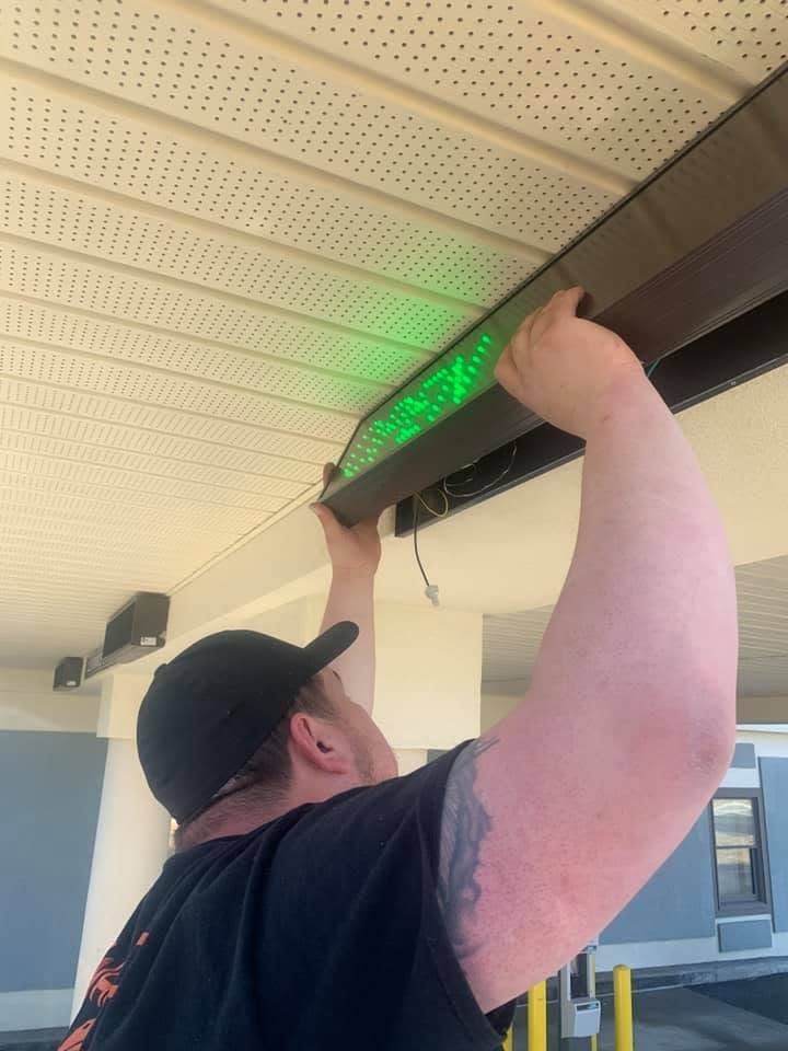 PrimeWire electrician servicing an illuminated commercial sign