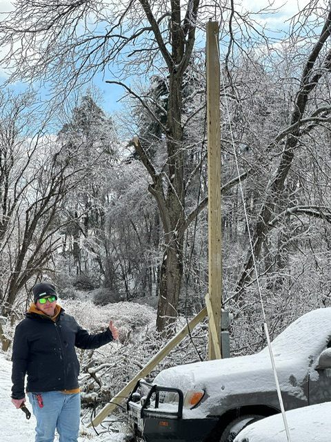 PrimeWire electrician on an ice-storm service call beside a new temporary pole