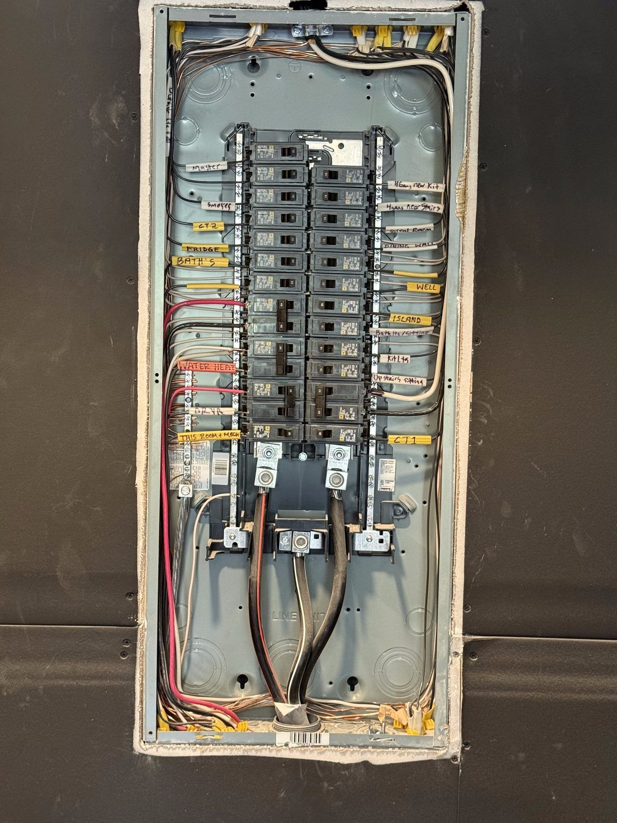 New breaker panel recessed in drywall with every circuit labeled