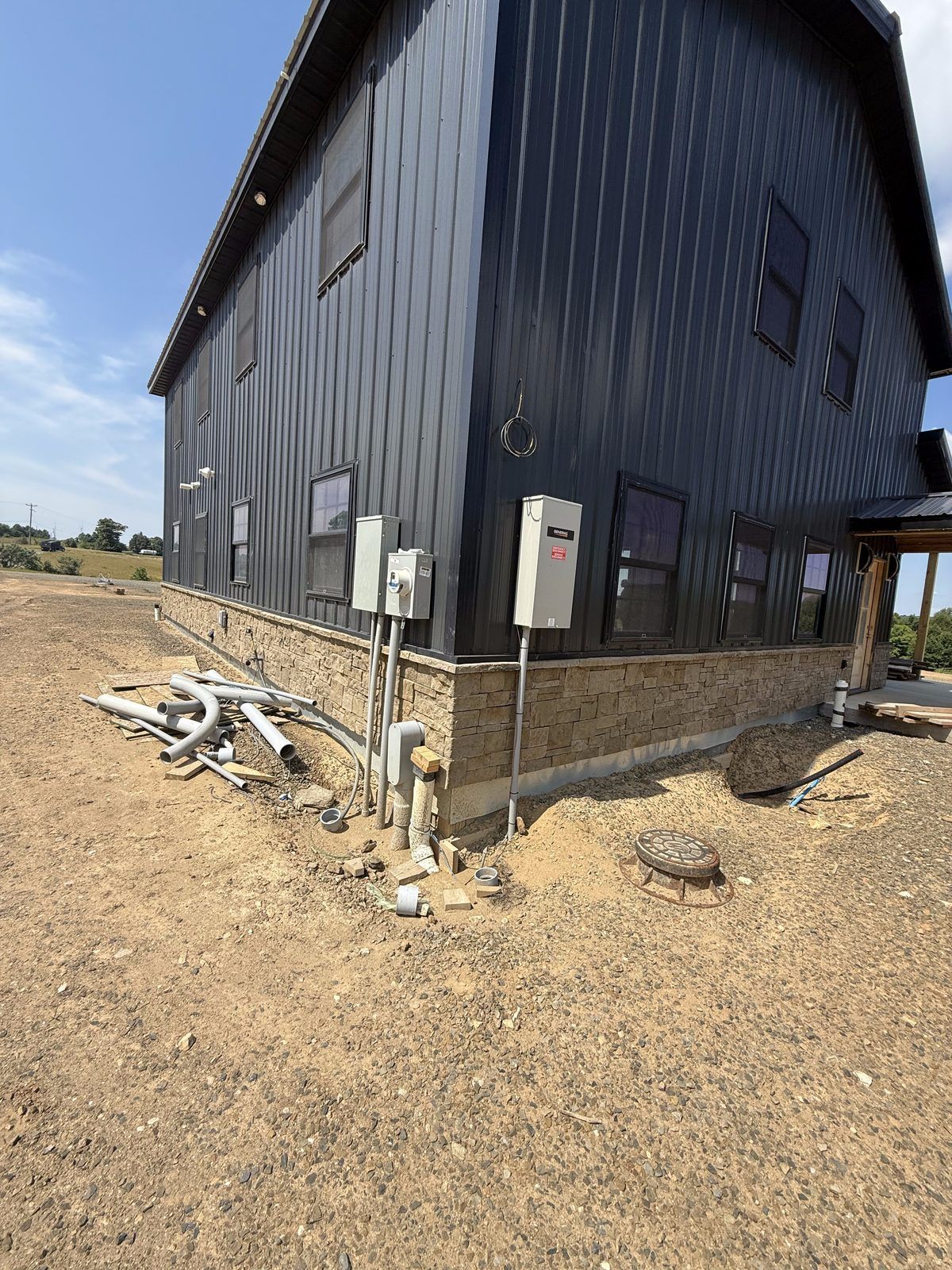 Meter and service disconnects installed on a new metal barndominium